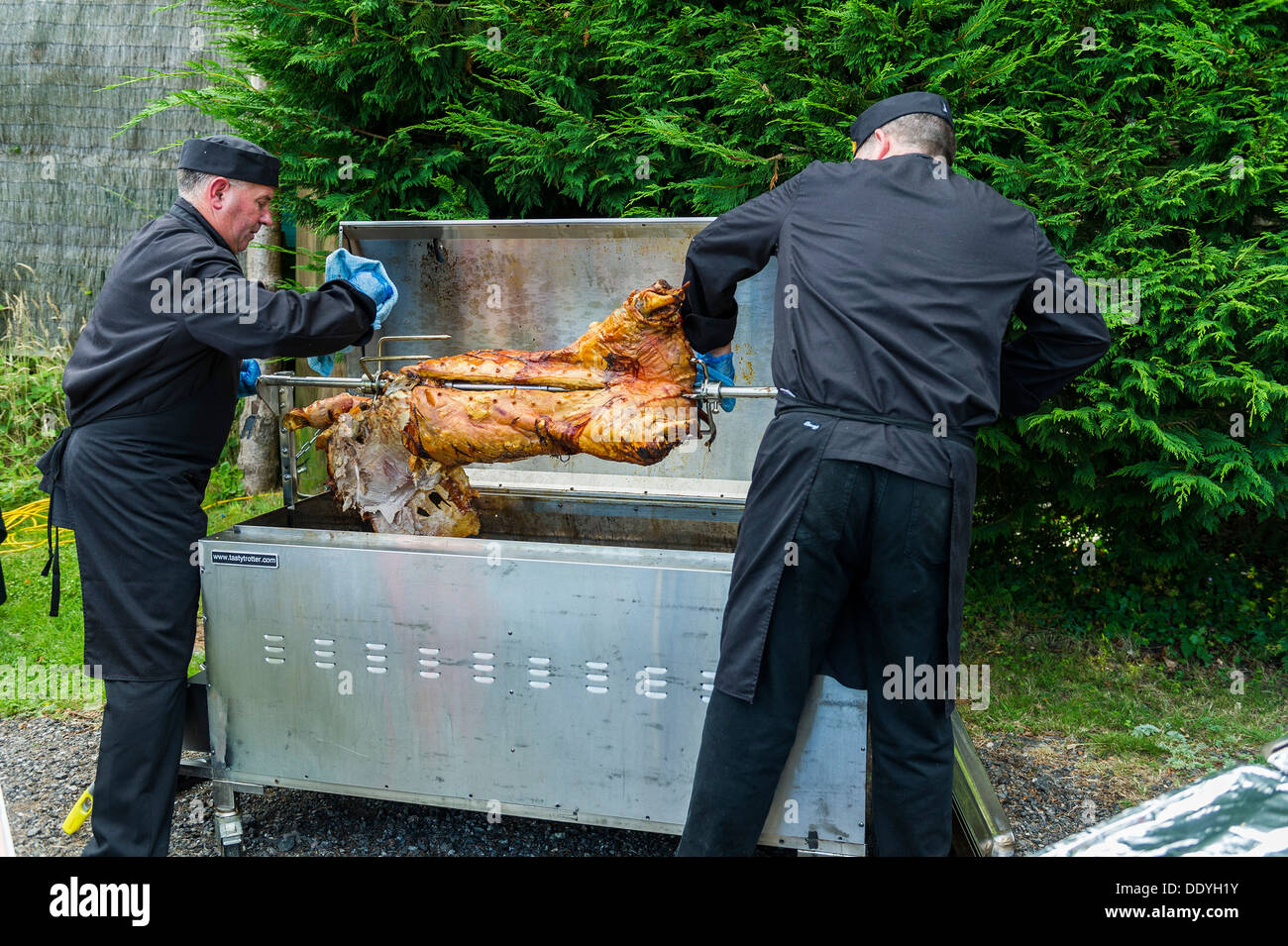 A hog roast being prepared for carving and serving. Stock Photo