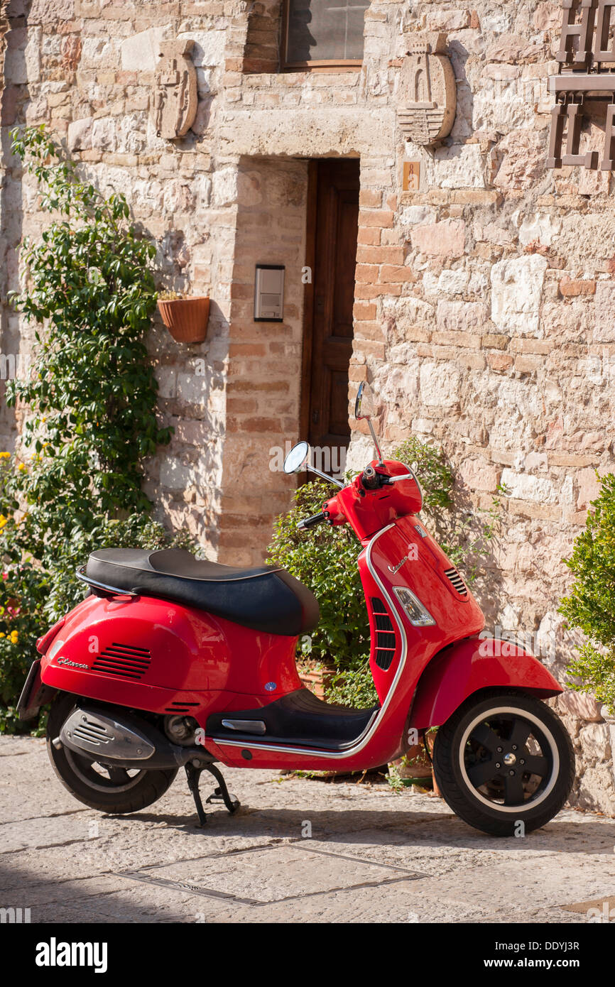 Red Vespa scooter in Italian Village Stock Photo