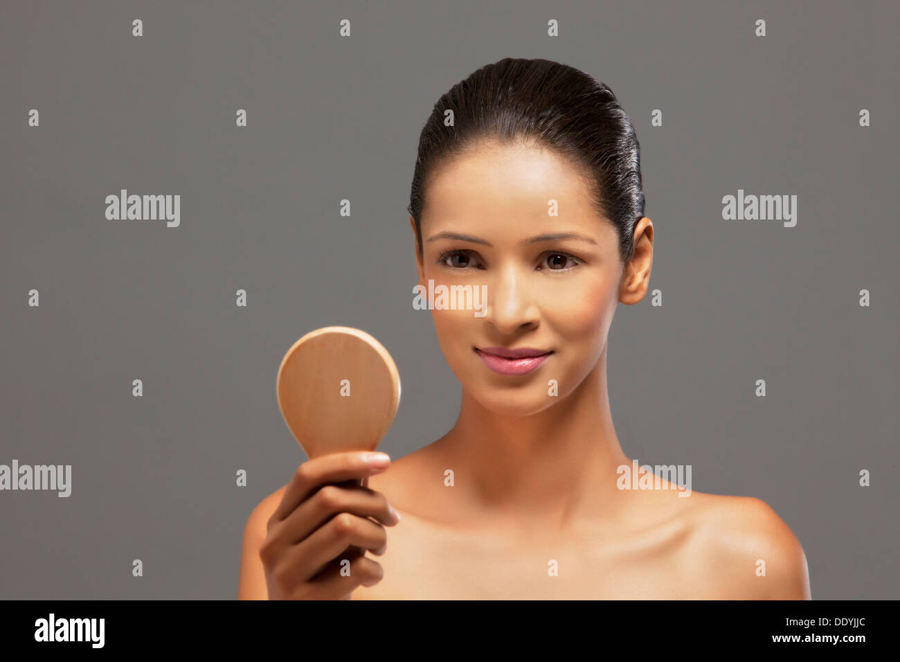 Close-up of beautiful young woman with a hand mirror Stock Photo