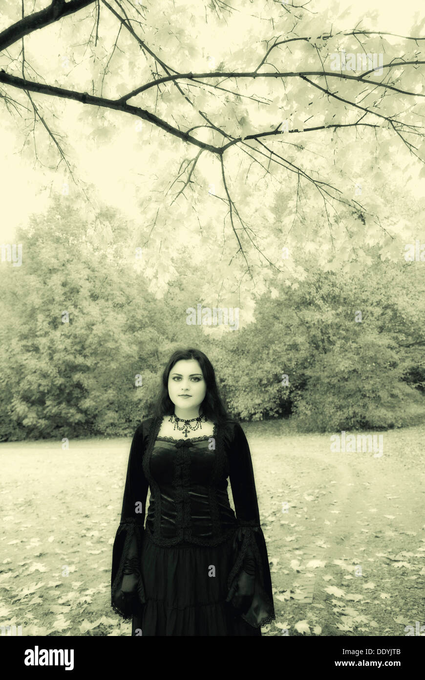 Woman, Gothic look, romantic-Gothic, standing under a tree Stock Photo