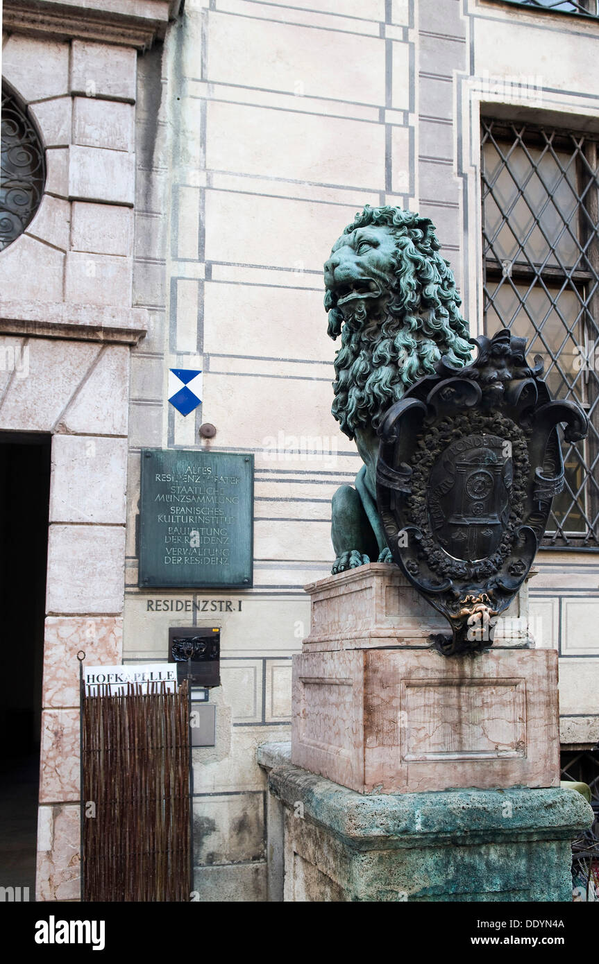 Lion sculpture in front of the Munich Residence, Residenzstrasse 1, the lower lip of the lion looking polished as it is rubbed Stock Photo