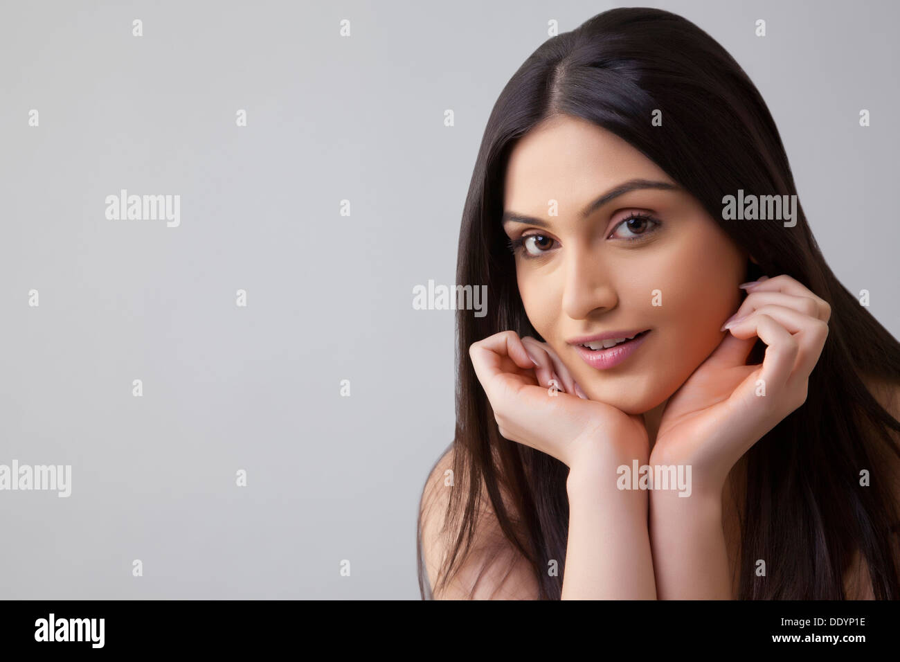 Portrait of pretty young Indian woman with long hair isolated over ...