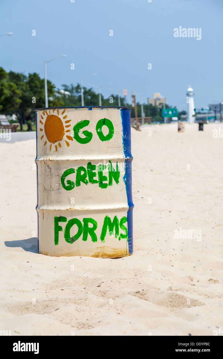 Go Green For Mississippi painted on trash barrel  on the Gulf of Mexico beach at Biloxi Mississippi Stock Photo