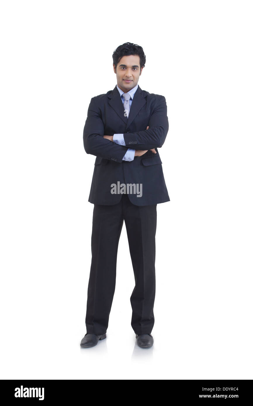 Full length portrait of young businessman with arms crossed isolated ...