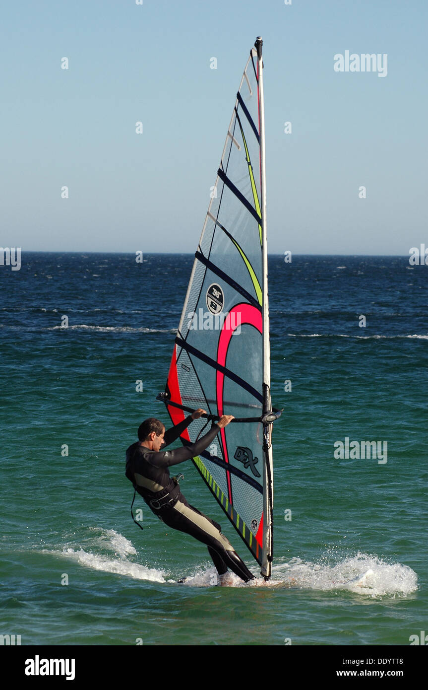 A windsurfer windsurfing at the north Atlantic Ocean in Portugal Stock