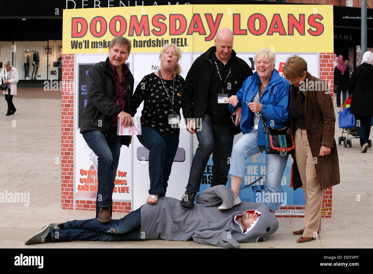 Bournemouth, UK 9 September 2013. A 'pop up doomsday payday loan shop' is set up in Bournemouth Square to coincide with latest Unite figures on the amount people are borrowing to get through the month; reportedly a new survey reveals the amount of money that hard pressed Unite members have to borrow each month to make ends meet has tripled since 2012 to £660. Stock Photo
