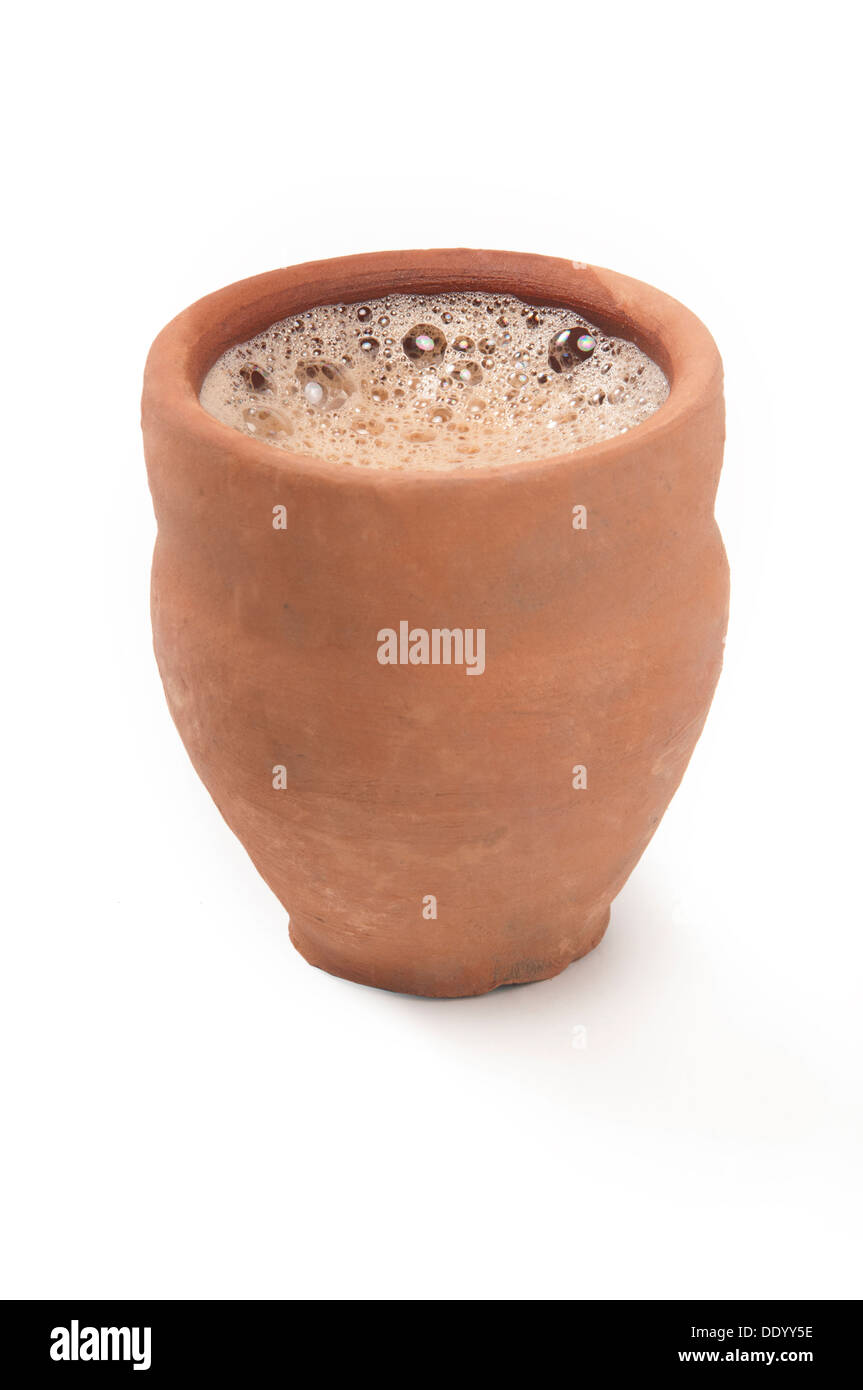Closeup of chai in traditional cup made of mud isolated over white