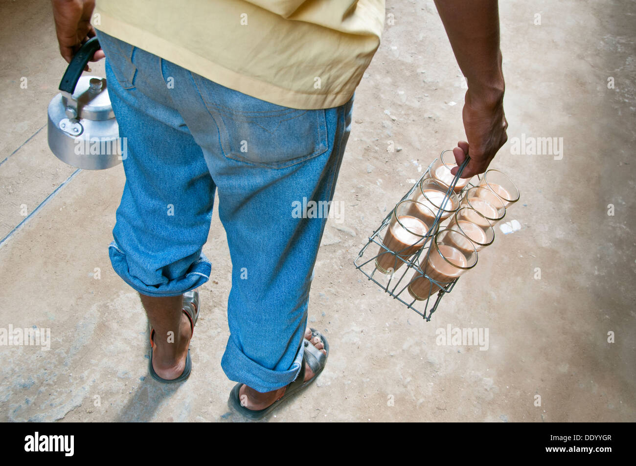 Rear view of Indian street seller with tray milk tea and kettle Stock Photo