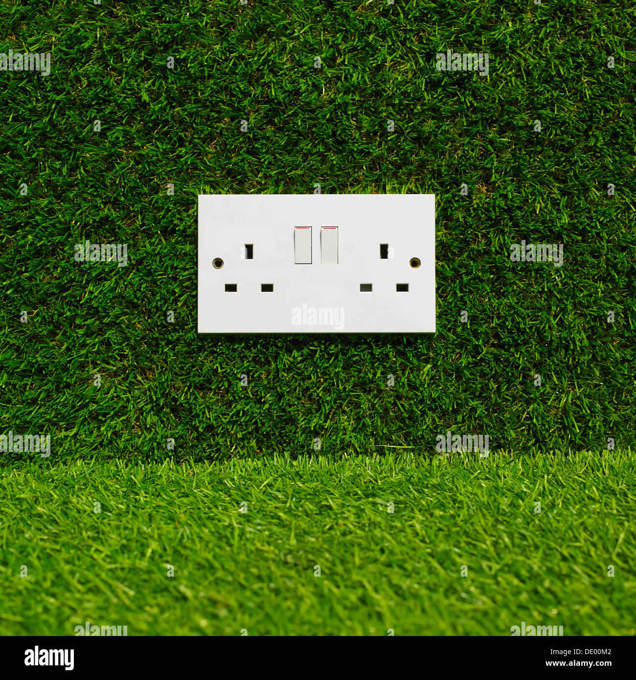 Electrical Plug Socket On Grass Background. Stock Photo