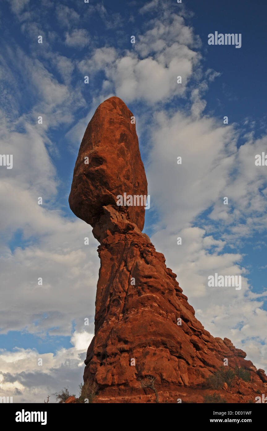 Balanced Rock standing in Arches National Park under white clouds in Utah Stock Photo