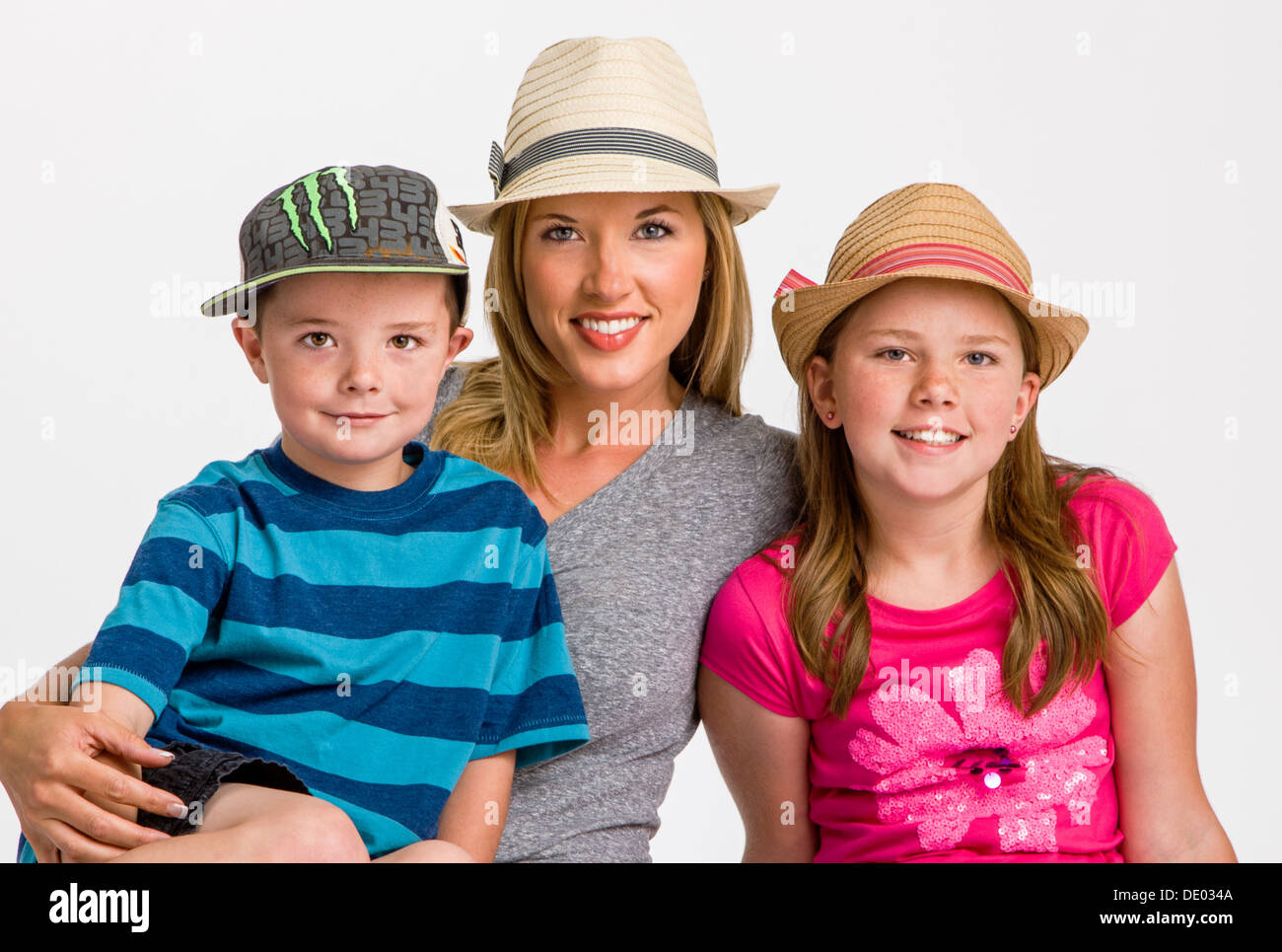 Studio portrait of young mother with five year old son and ten year old daughter Stock Photo