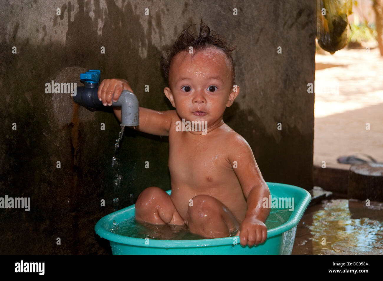 Little Vietnamese boy being bathed, Phu Quoc Vietnam, Asia Stock Photo