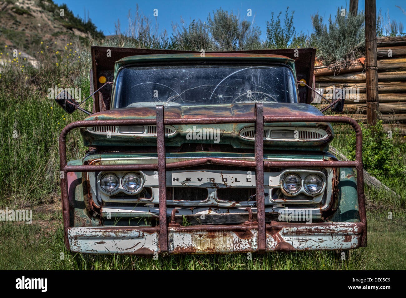 Old, abandoned, rusting Chevrolet coal mining dumb truck. Battered & well used in coal mine in Alberta badlands, near Drumheller Stock Photo