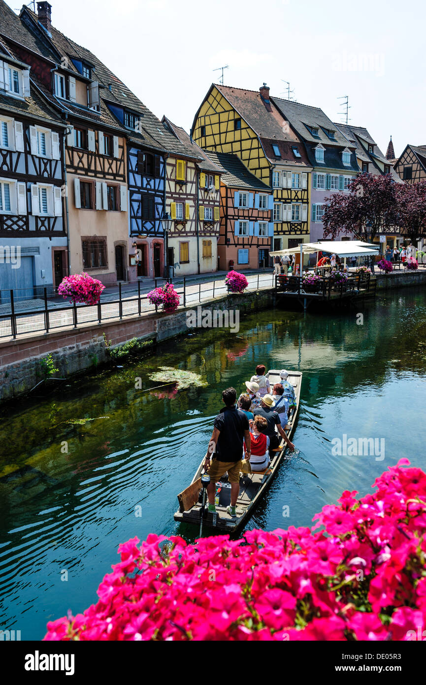 Tourists sightseeing in a punt in the area known as 'Little Venice' in Colmar, Alsace, France Stock Photo