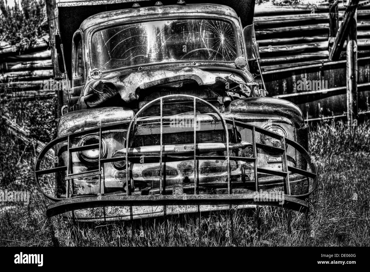 Old, abandoned, rusting coal mining dumb truck. Battered & well used in coal mine in Alberta badlands, near Drumheller. B&W Stock Photo
