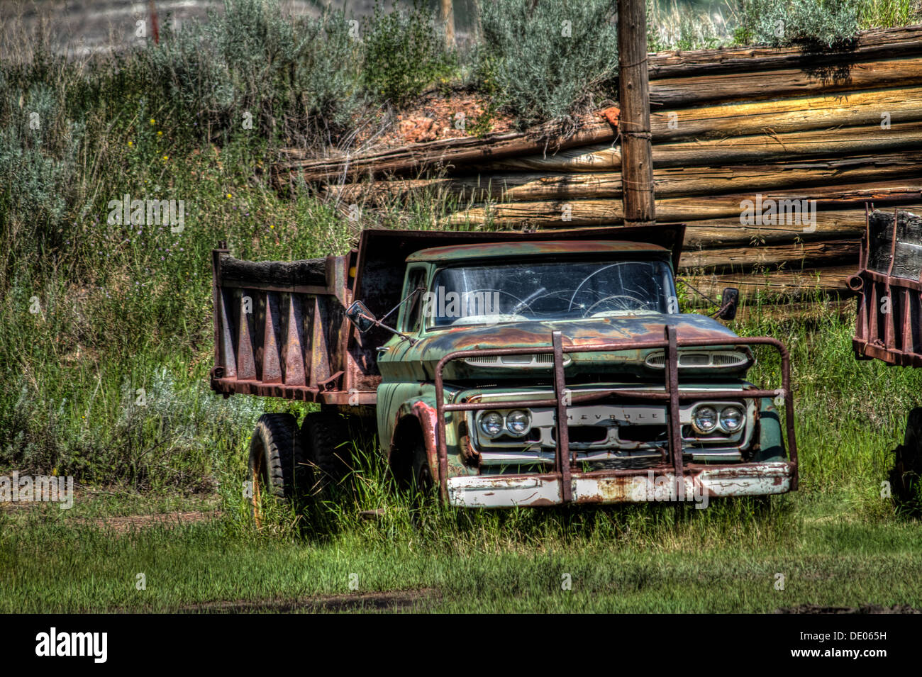 Old, abandoned, rusting Chevrolet coal mining dumb truck. Battered & well used in coal mine in Alberta badlands, near Drumheller Stock Photo