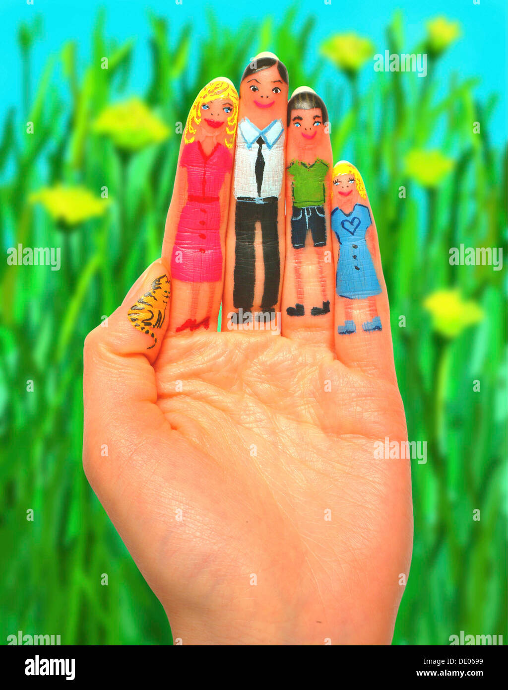 Family painted on the fingers of a hand, flower meadow, composing Stock Photo