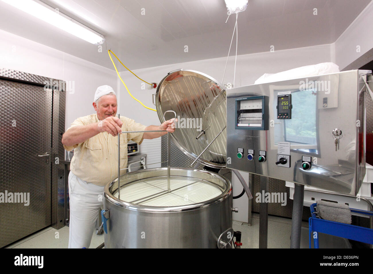 Cheesemaker during the production of goat cheese at the Goas-Alm cheese factory Stock Photo
