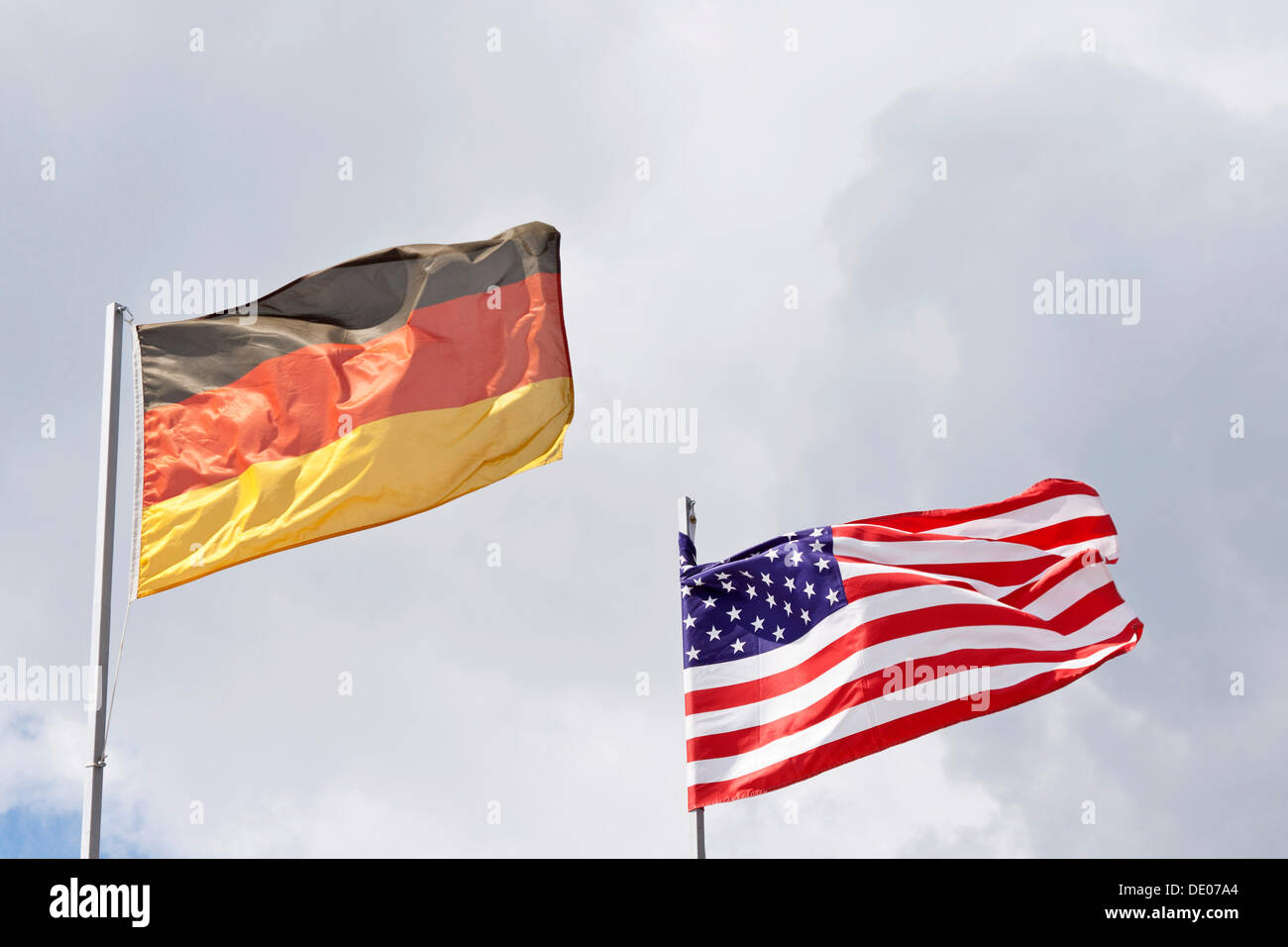 The national flags of Germany and the USA blowing in the wind, stormy, symbolic image Stock Photo