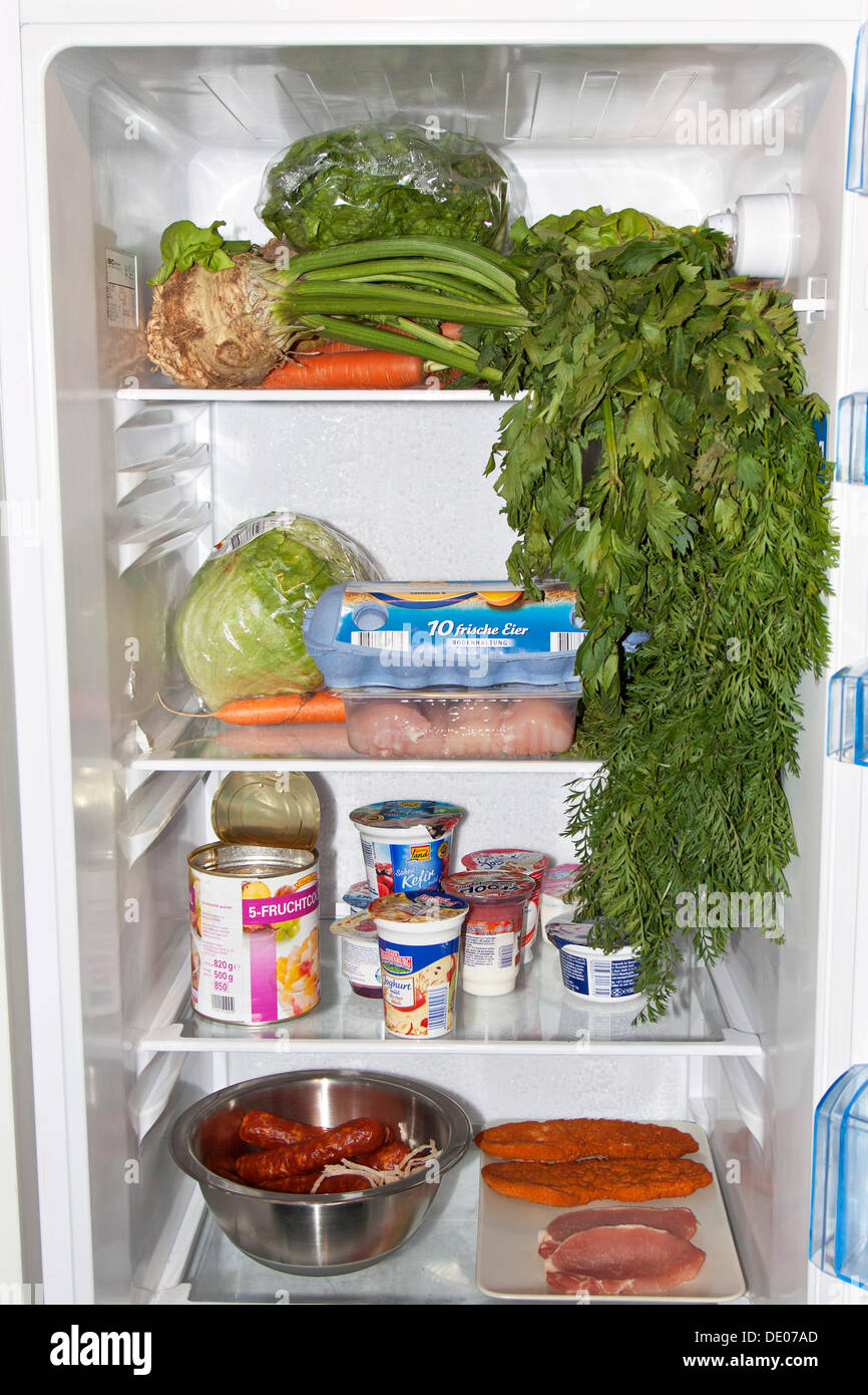 Food stored in the wrong place in a fridge, uncovered meat Stock Photo