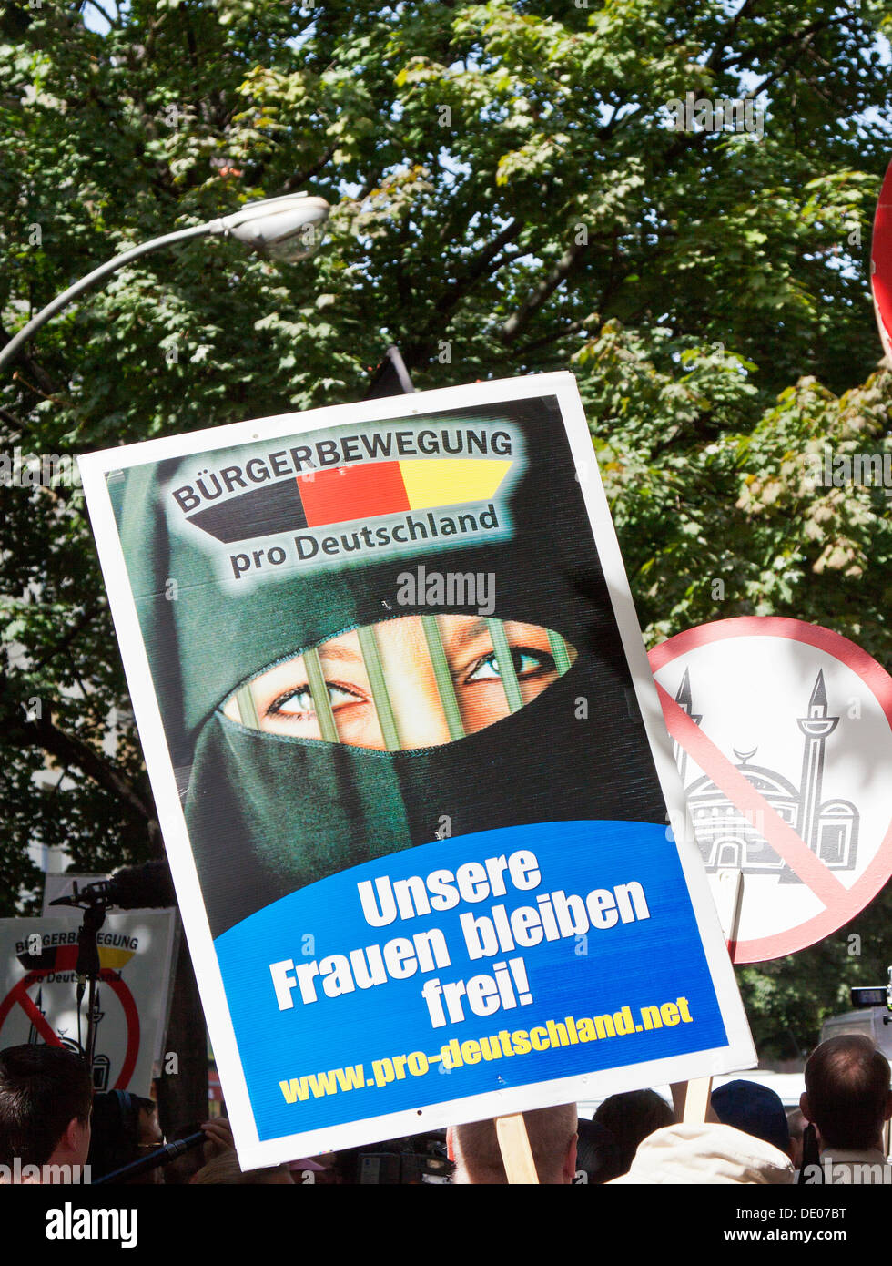 Sign with a veiled woman, lettering 'Unsere Frauen bleiben frei!', German for 'Our woman remain free!', Pro Germany Citizens' Stock Photo