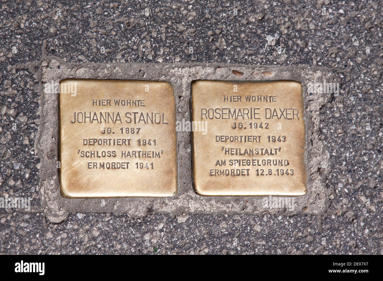 Stolperstein memorial, German for stumbling block, woman deported 1941 to Schloss Hartheim, murdered in 1941, and a girl, 1, Stock Photo