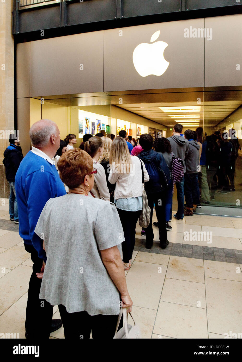 People in a queue queuing outside the Apple Store, Grand Arcade shopping centre, Cambridge UK Stock Photo
