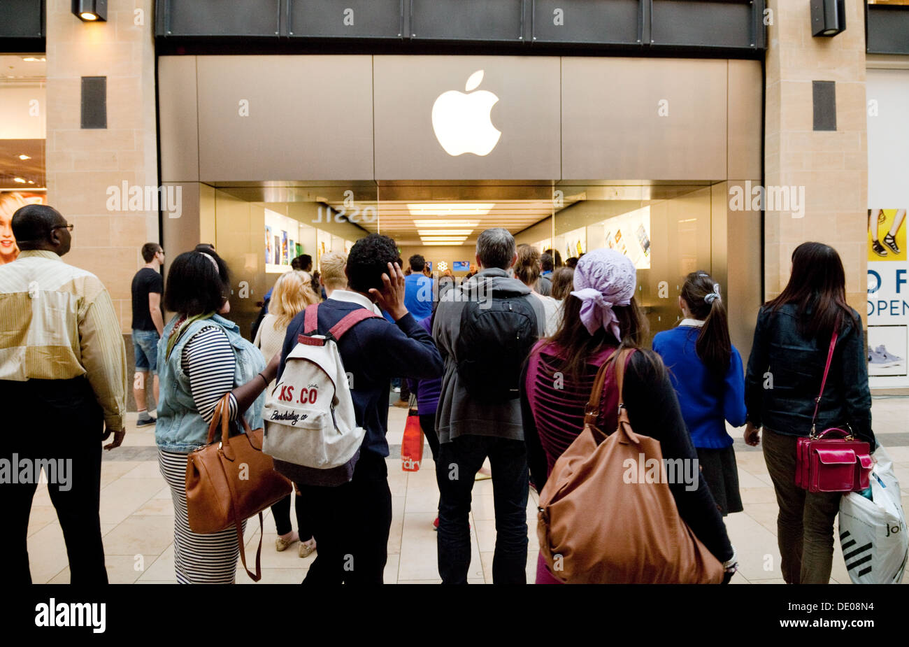 A crowd of people outside the Apple Store, Grand Arcade, Cambridge UK Stock Photo