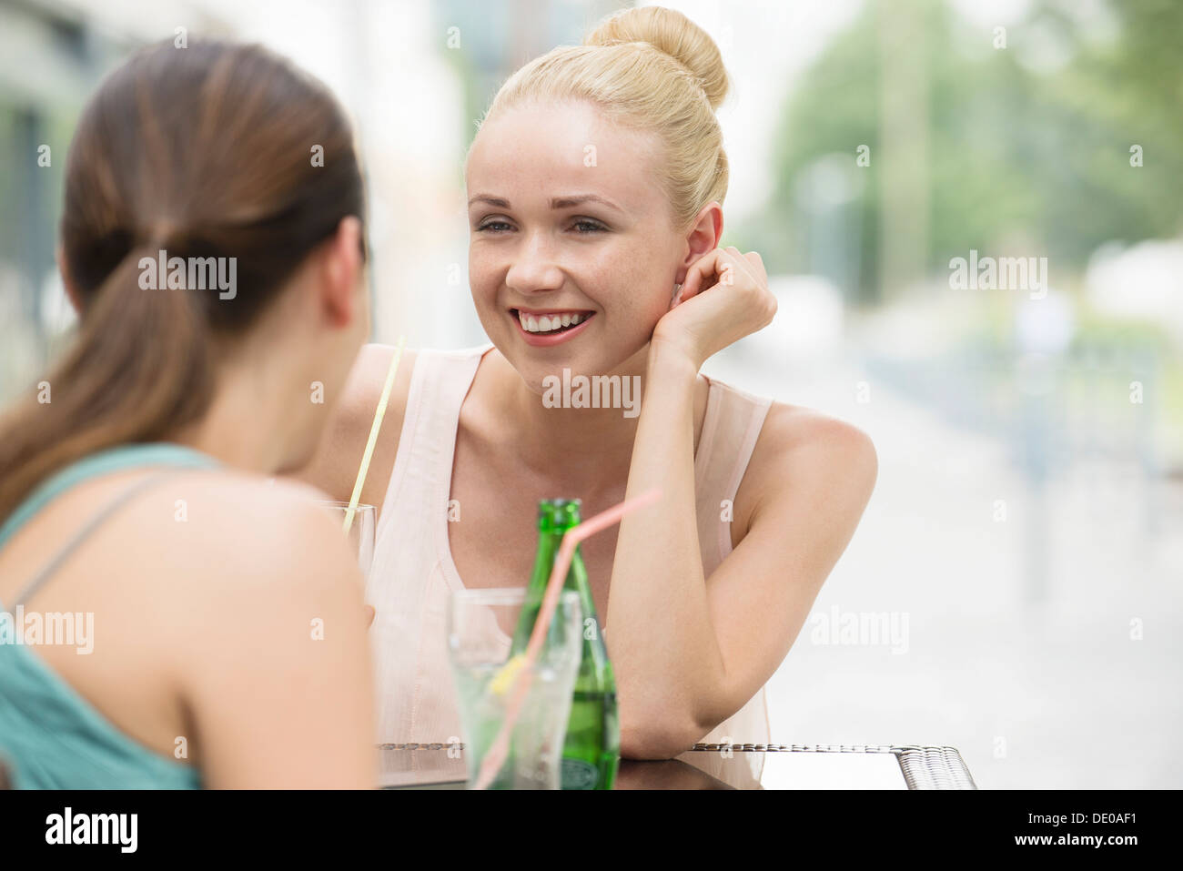 Women chatting at sidewalk cafe Stock Photo