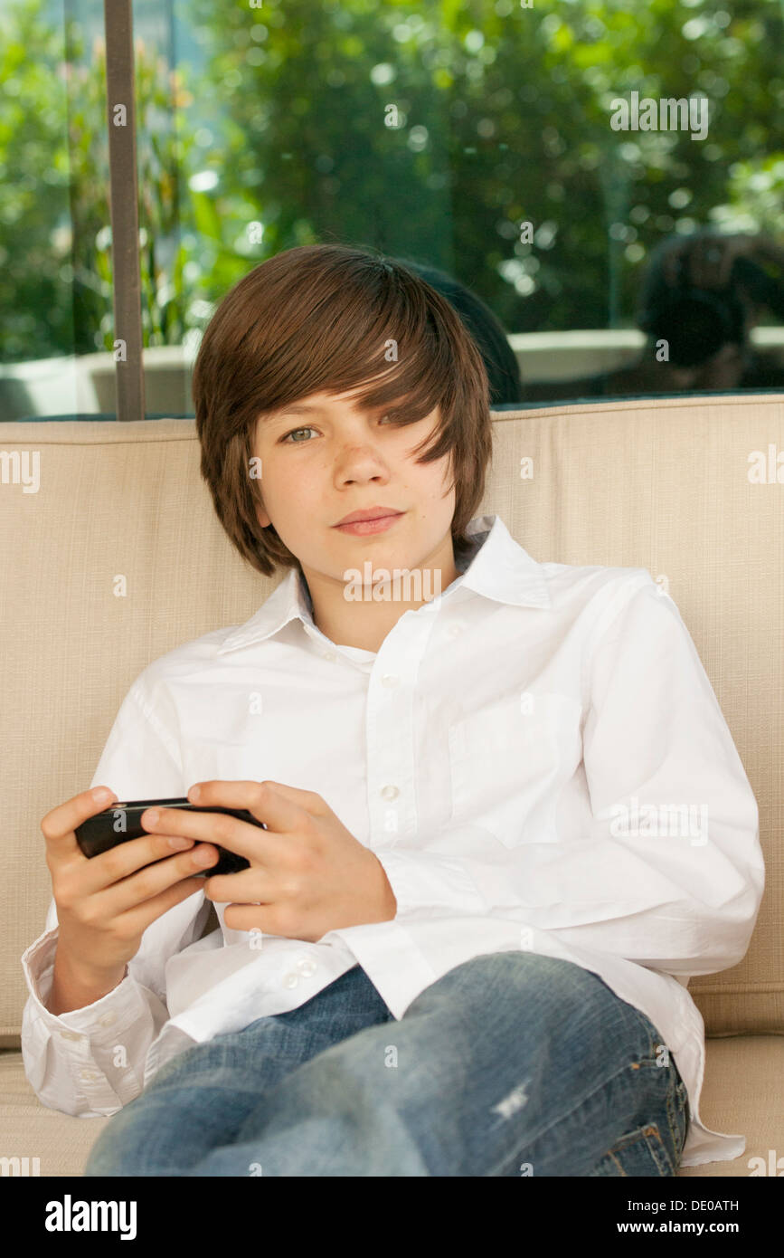 Teenage boy using cell phone Stock Photo