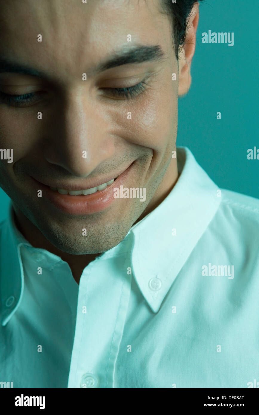 Man smiling, looking down, close-up Stock Photo