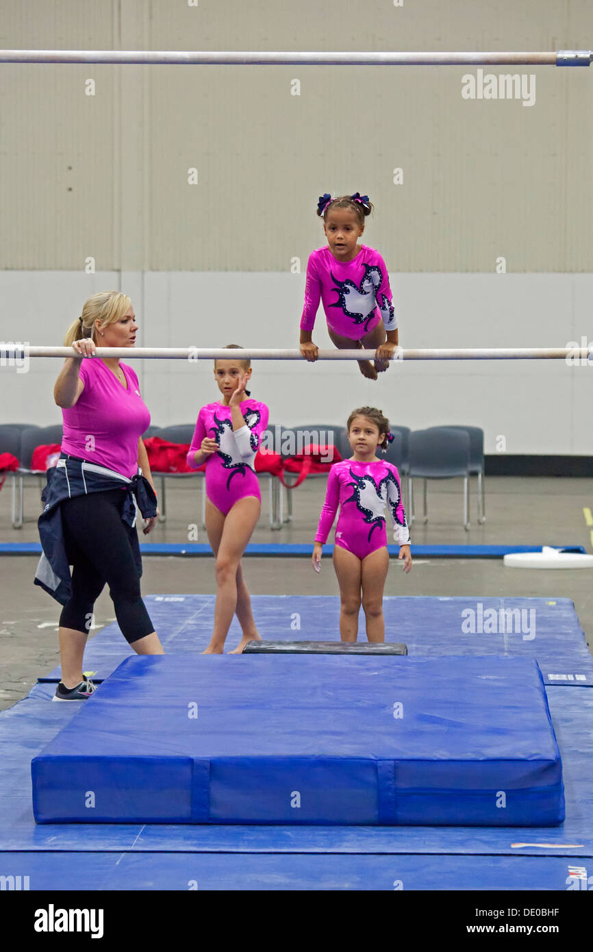 Detroit, Michigan A coach watches as girls warm up on the parallel