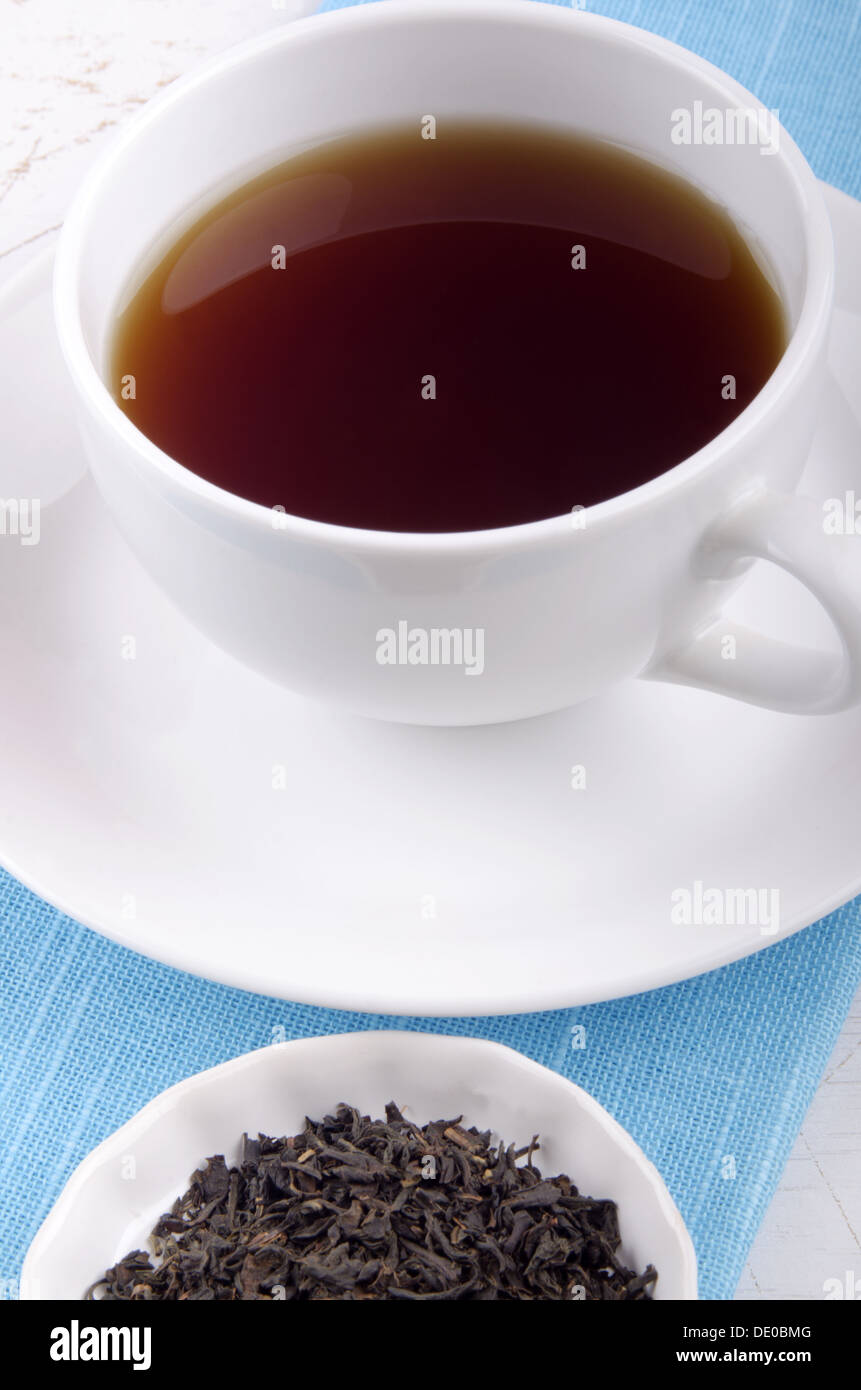 Want Some Tea english breakfast tea in a white cup and some loose tea Stock Photo - Alamy