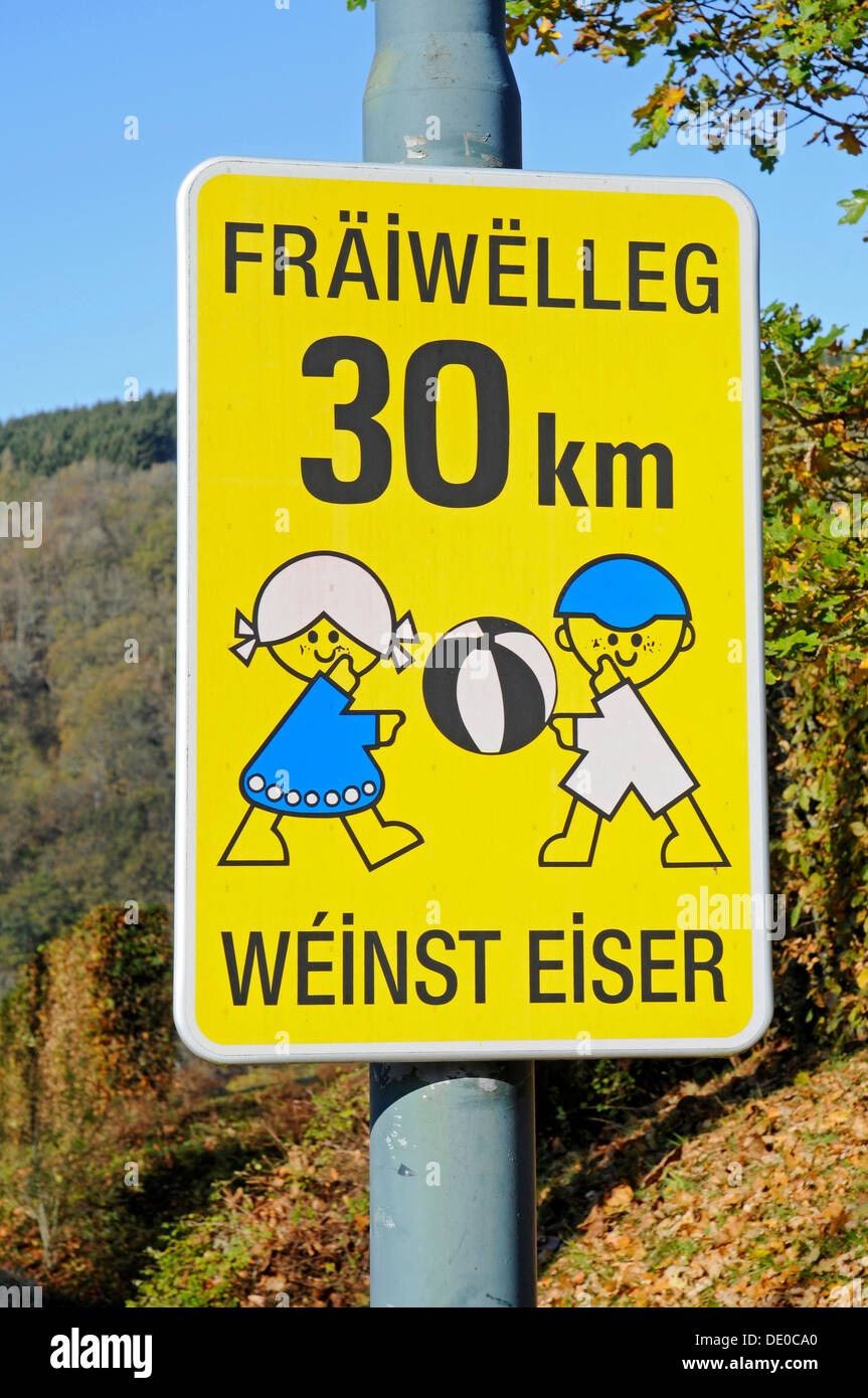 Sign, voluntarily 30 km, take care of children playing, drive slowly, in the language of Luxembourgish, Luxembourg, Europe Stock Photo