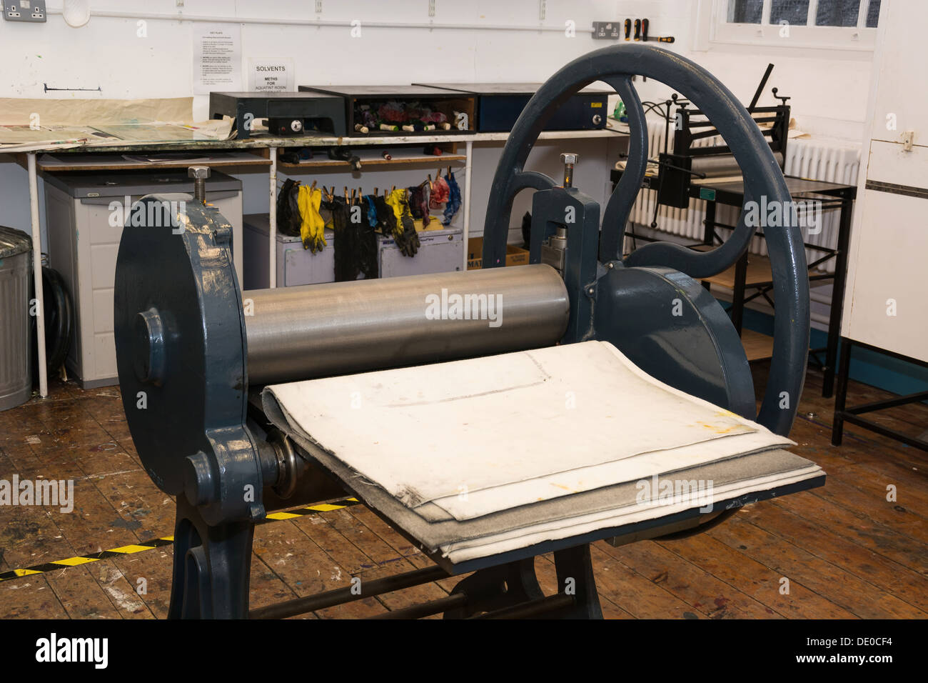 An old hand driven roller press in a college workshop Stock Photo