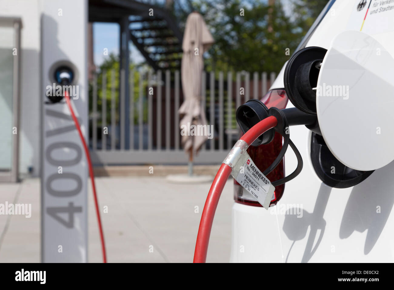 Electrical plug, a Volkswagen Golf being charged in front of the Autostadt museum and adventure park in Wolfsburg, Lower Saxony Stock Photo