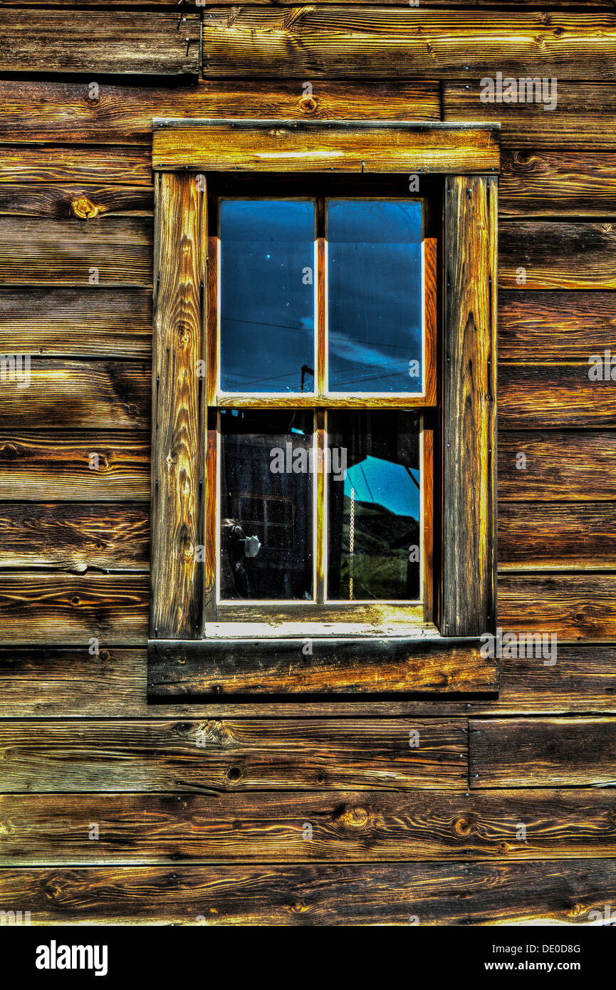 An old rustic window, on the side of a weathered, old building. Showing ...
