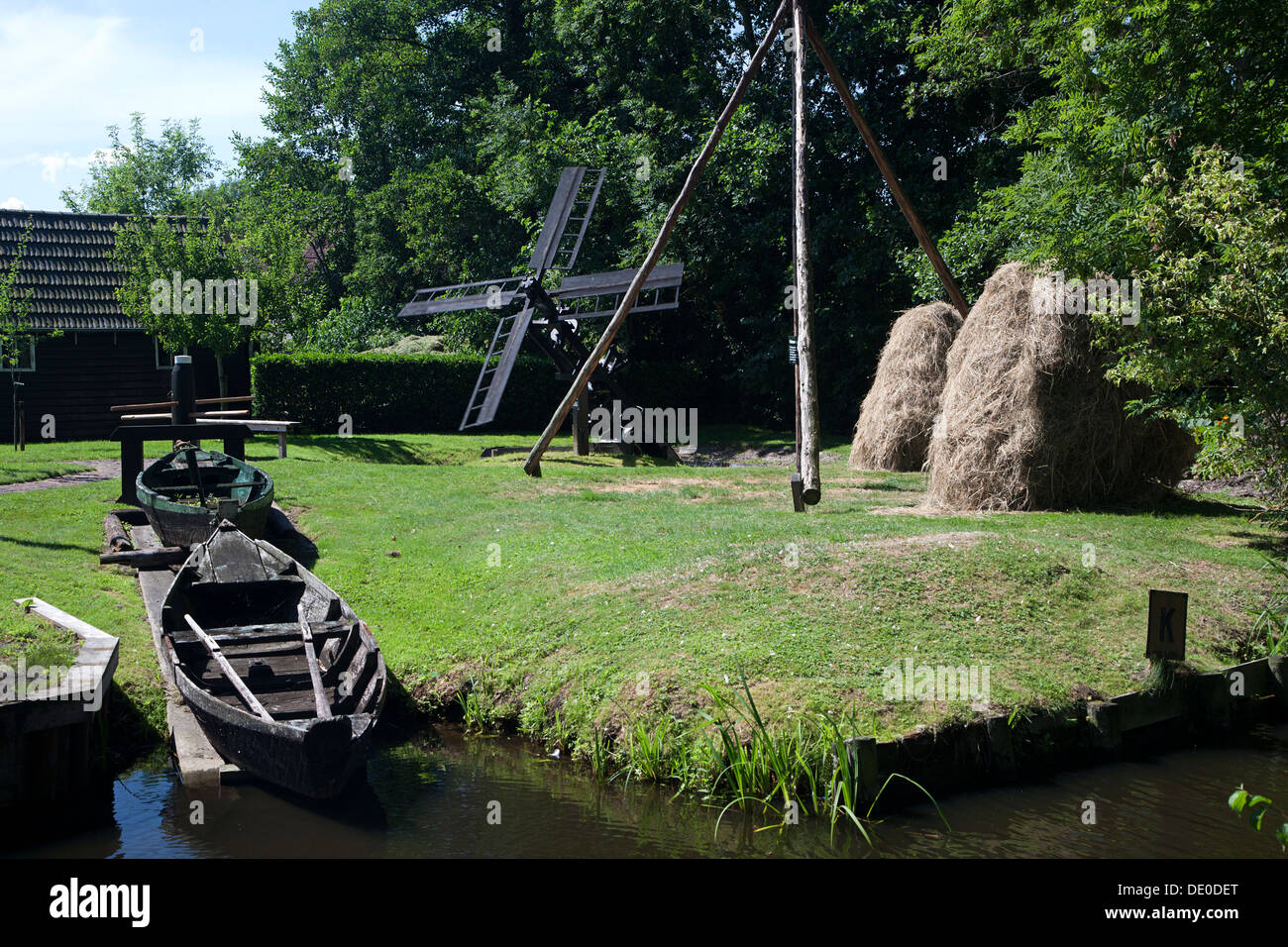 Historic boats on slipway and tjasker in museum 't Olde Maat Uus, Giethoorn, Ovrijssel, Netherlands Stock Photo