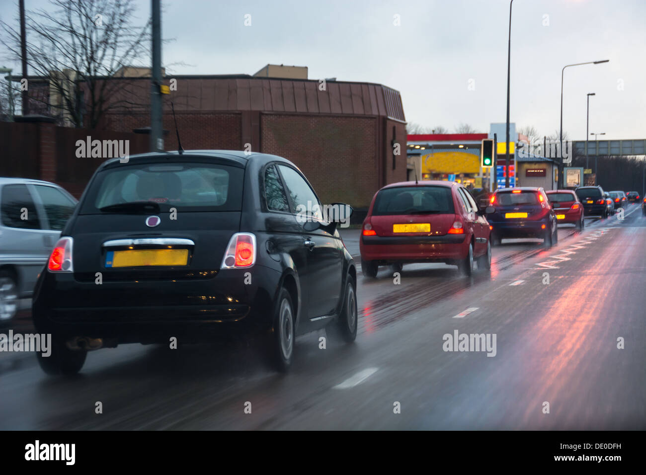 A line of cars on a busy rainy street Stock Photo - Alamy