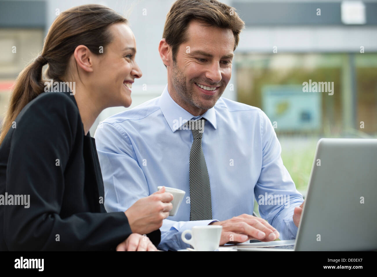 Business associates having coffee while collaborating on project Stock Photo