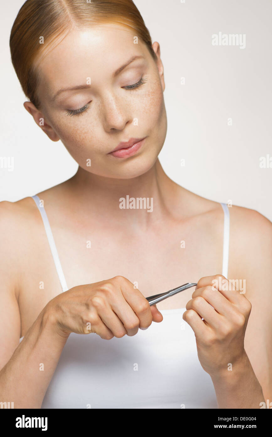 Young woman cutting cuticle Stock Photo