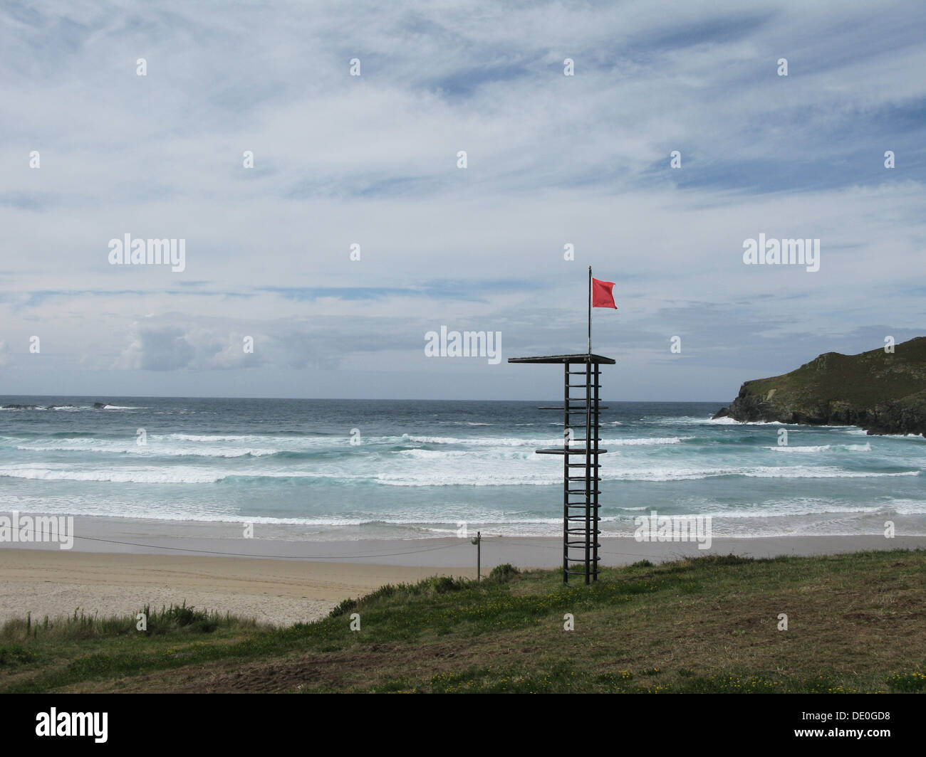 Red flag indicating dangerous conditions at empty beach Stock Photo Alamy