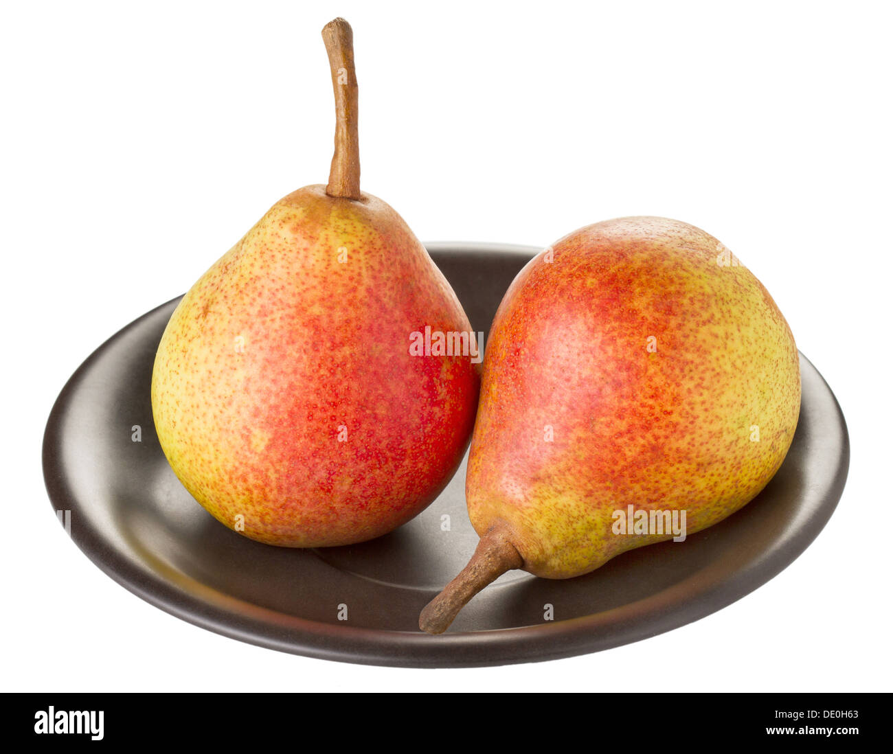 Two ripe pears on a black plate on a white background Stock Photo