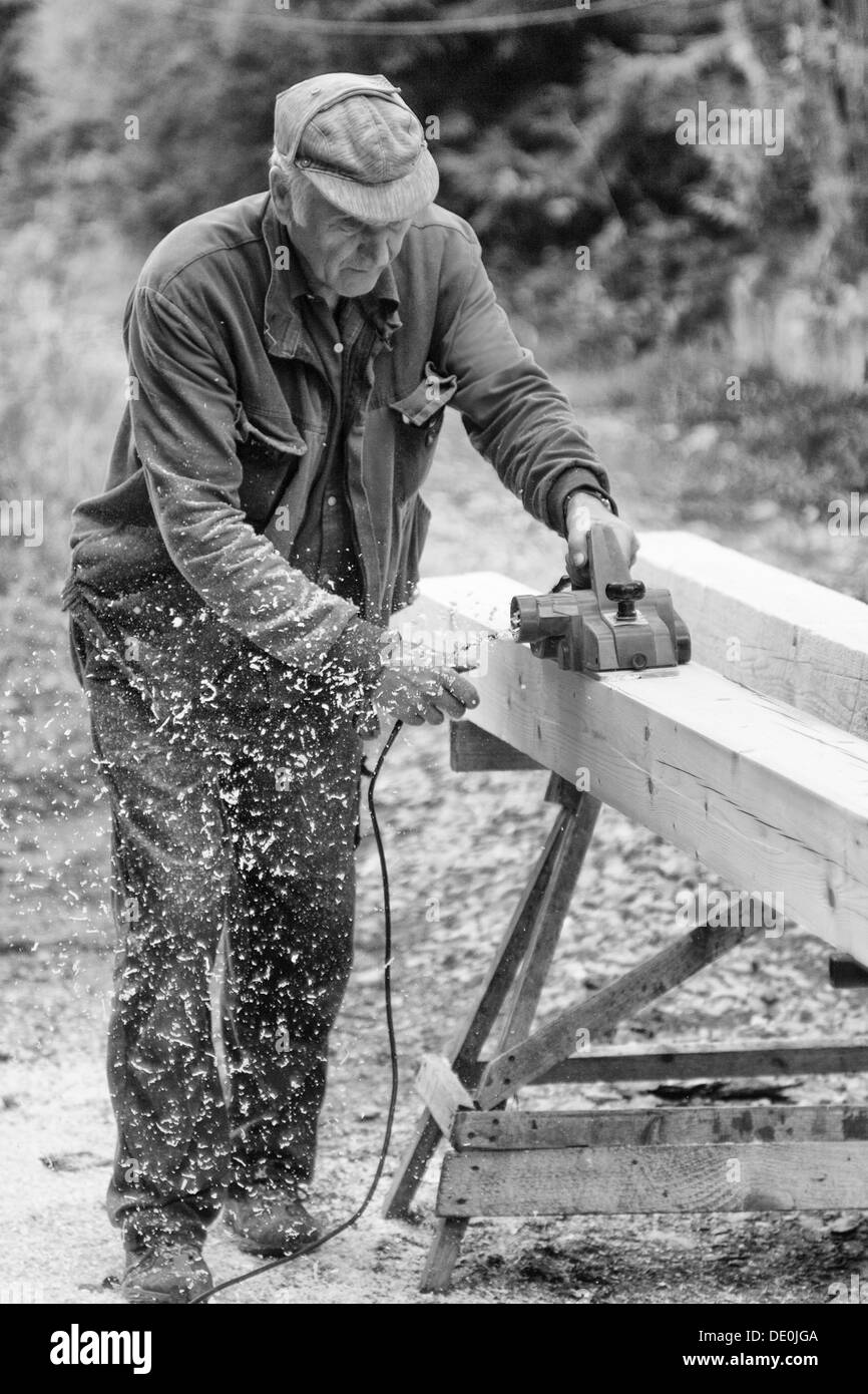 Joiner in work with electrical plane Stock Photo