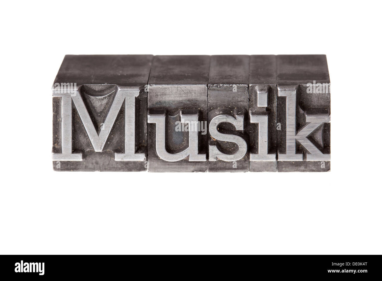 Old lead letters forming the word 'Musik', German for music Stock Photo