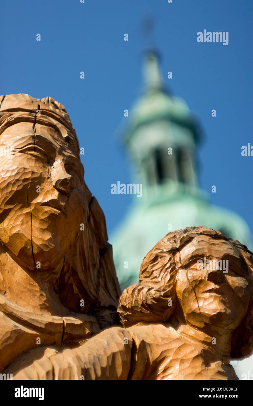Wooden statues in front of church Stock Photo