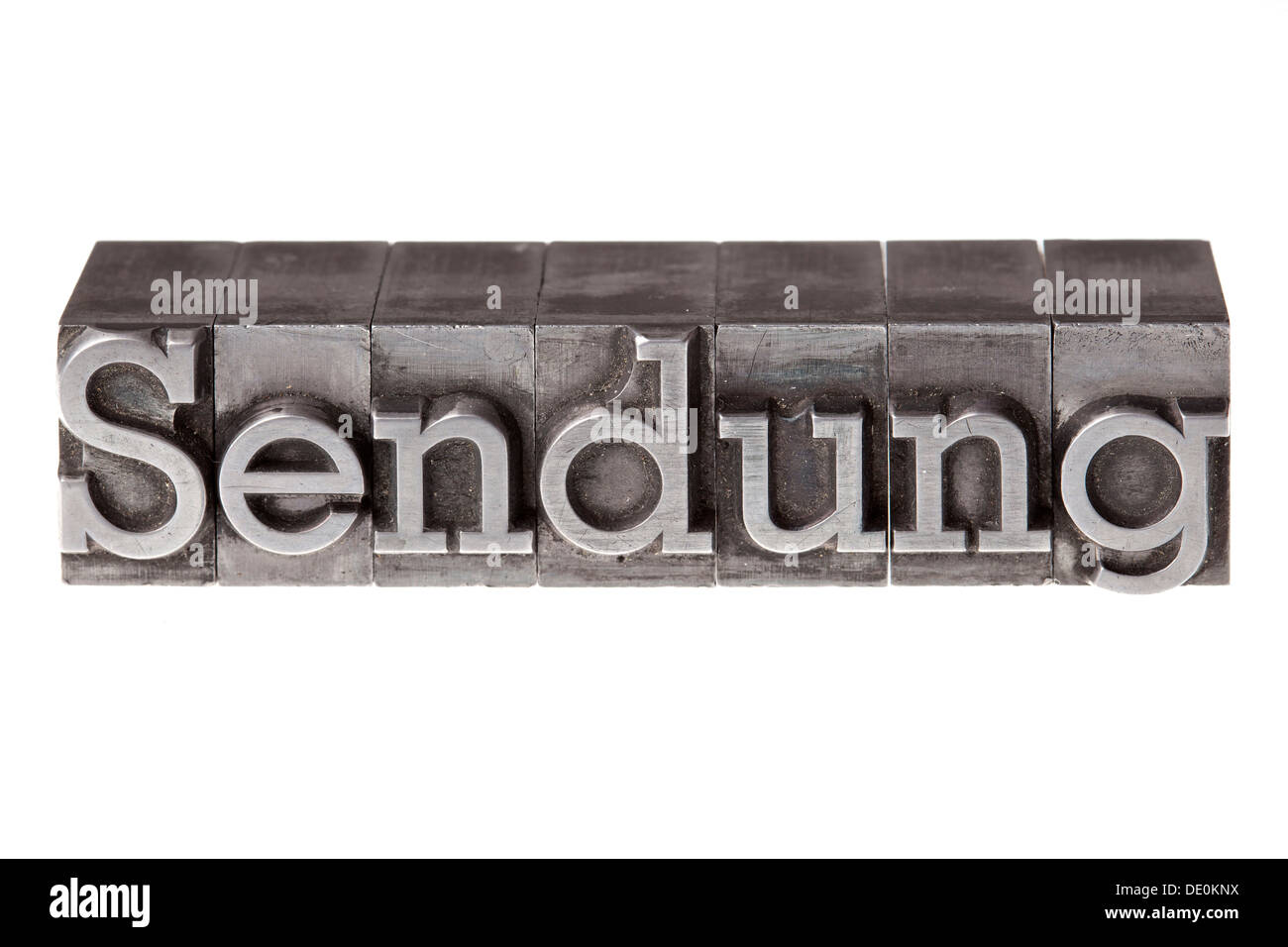 Old lead letters forming the word 'Sendung', German for consignment or programm Stock Photo