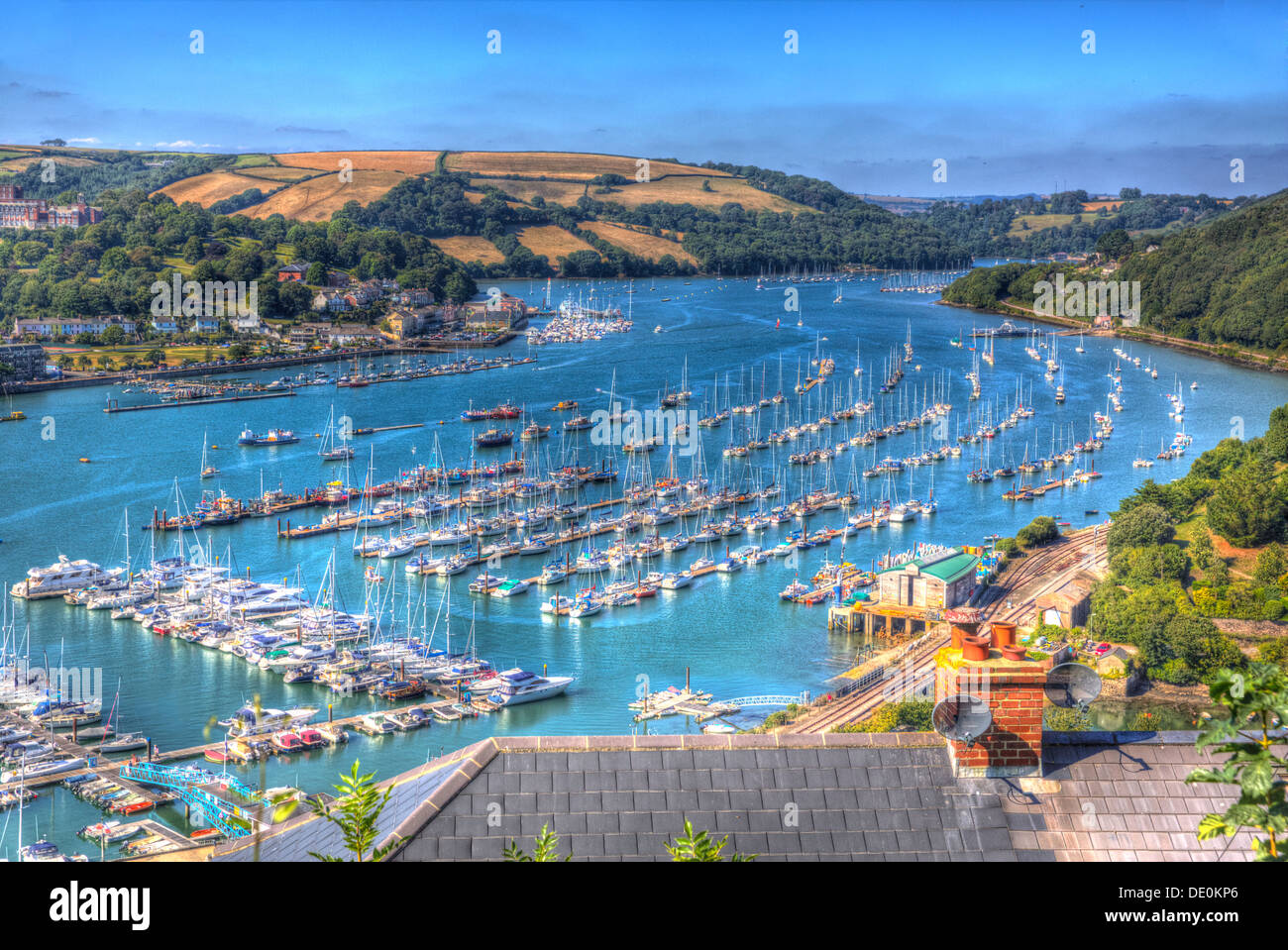 View of Dartmouth Devon and boats on Dart river in vivid HDR on blue sky summer day Stock Photo