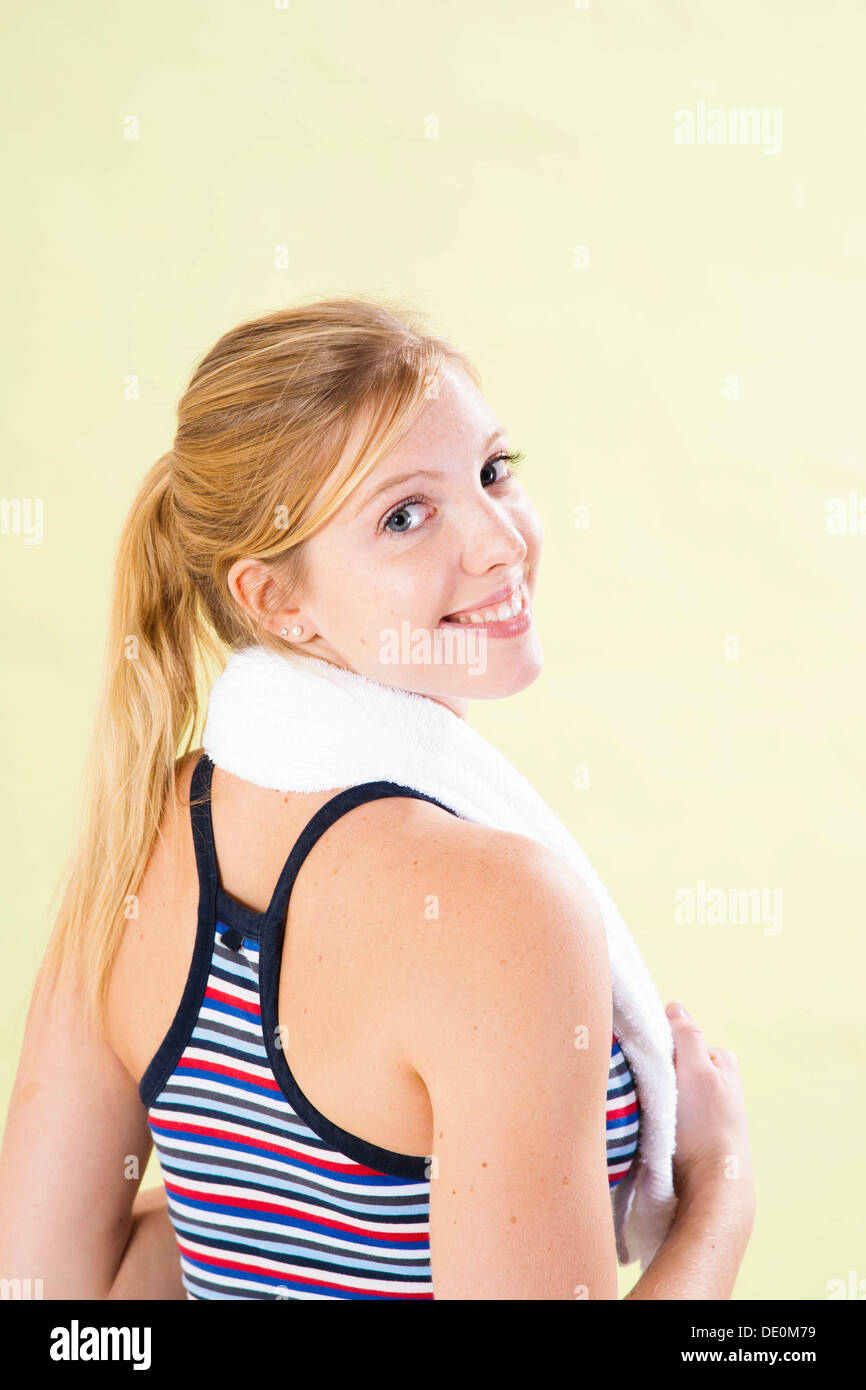 Smiling young woman after doing sport Stock Photo