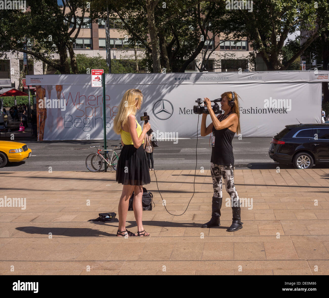 Crowds of fashionistas and photographers create a fashion scene outside of Spring 2014 Fashion Week Stock Photo